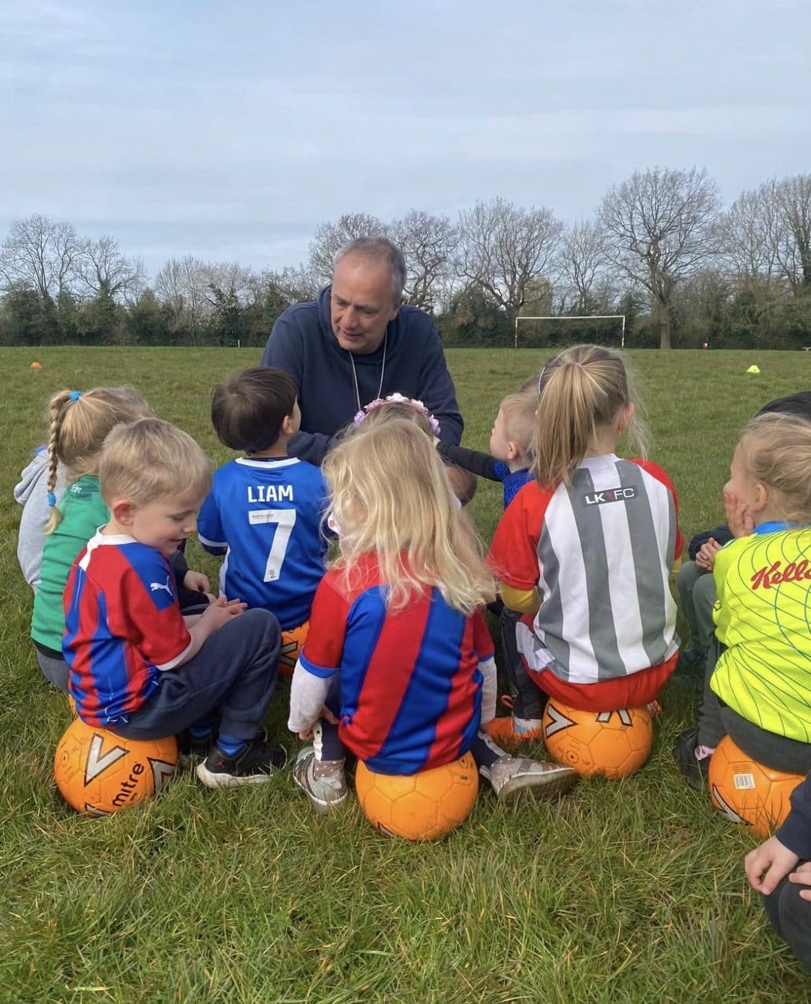 Andy talking with a circle of young Strikers players at Grove Park
