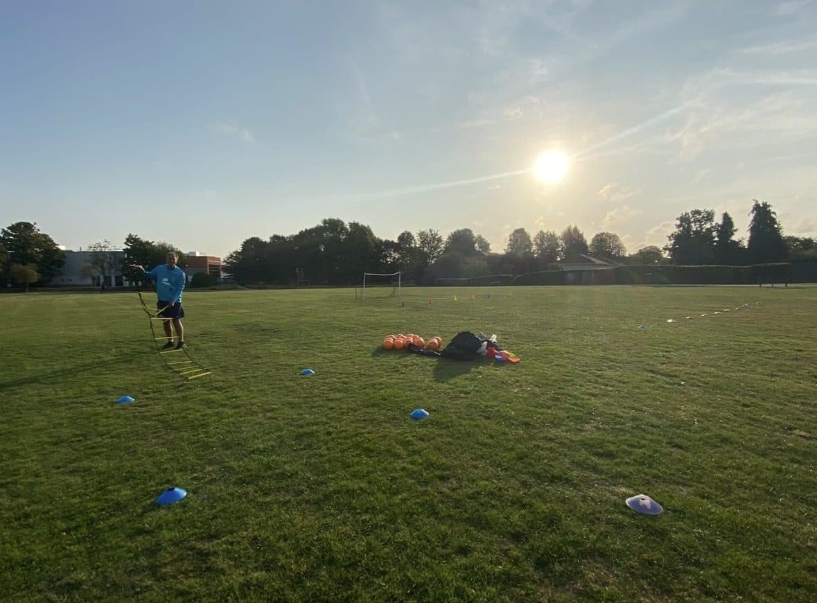 Coach setting up a golden-hour training session at Grove Park